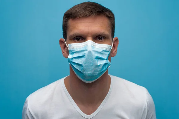 Portrait of man wearing an anti virus protection mask to prevent corona virus.