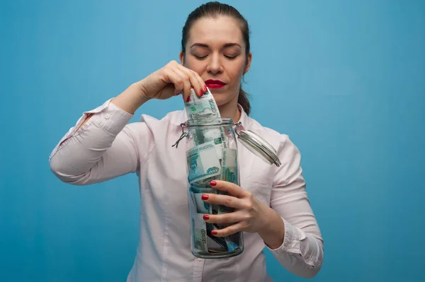 Young charming woman holds a jar with money — Stock Photo, Image