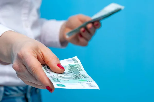 Hands of a young unidentified woman holding a pack of russian rubles — Stock Photo, Image