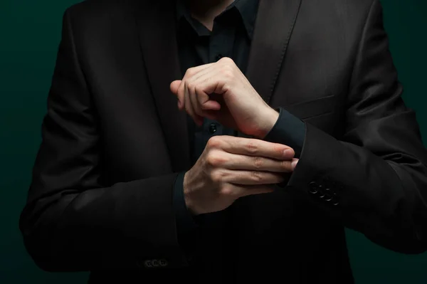 Close-up portrait of a handsome self-confident man in a red shirt and bow tie with glasses posing on a pale green background. The concept of gallant intelligent men Royalty Free Stock Images