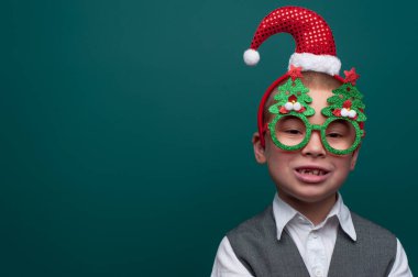 Noel aksesuarları takan pozitif küçük çocuk