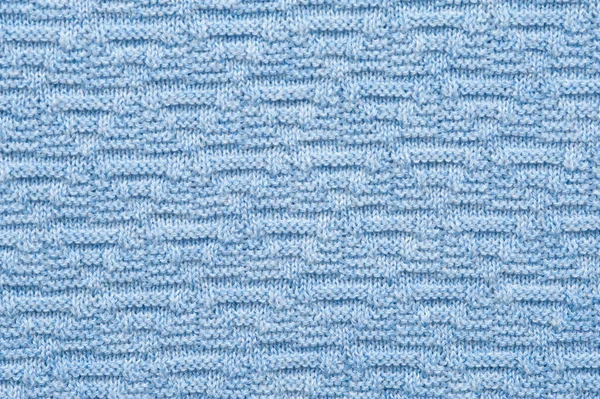 Close-up fragment of warm knitted blue sweatshirts. Concept of warm everyday things. clothing store concept. Advertising space. Place for text