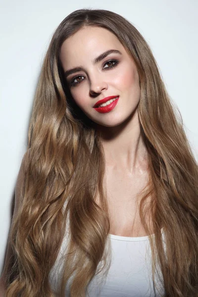 Young beautiful girl with long hair and red lipstick — Stock Photo, Image