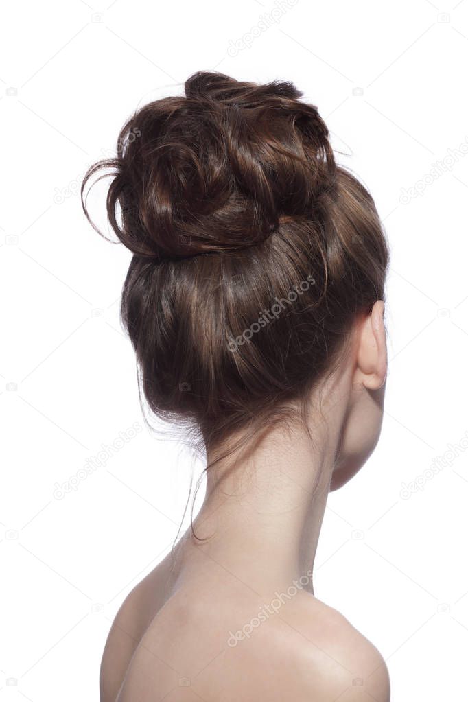 Back of young slim woman with fancy prom hair bun