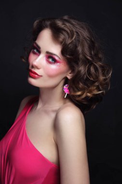 Portrait of young beautiful girl with curly hair and hot pink disco makeup clipart