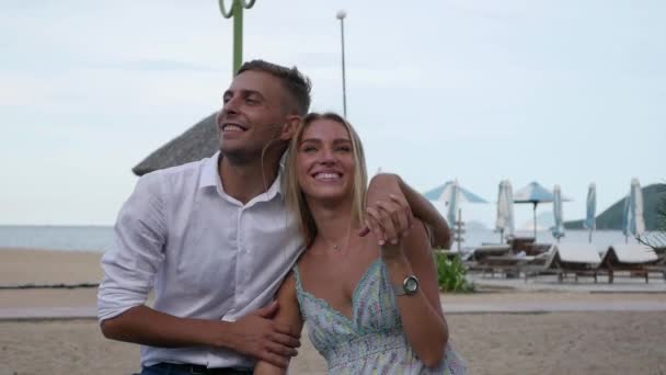 Joven pareja feliz abrazándose y besándose en el parque cerca del mar. Concepto romántico. HD, 1920x1080 . — Vídeo de stock