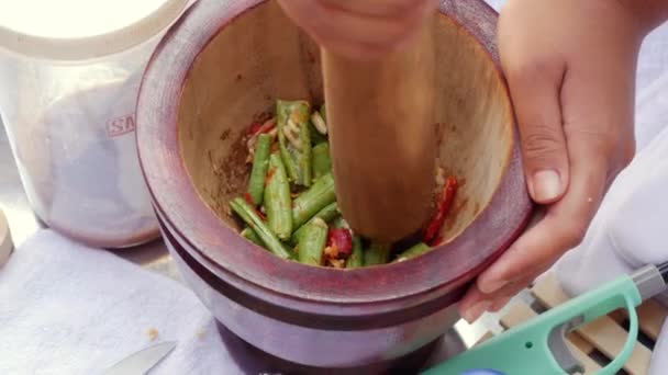 Mujeres tailandesas preparando ensalada de papaya verde som tam en mortero de madera con mortero. De cerca. 4k — Vídeos de Stock