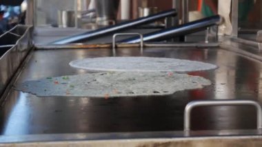 Masala dosa is a South Indian food. Chef make masala Dosa or dosai with potato stuffed inside. South Indian vegetarian, traditional and popular breakfast, with butter. 4k