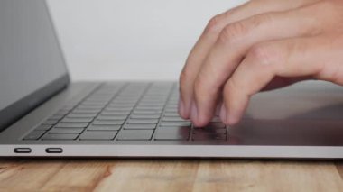 Erkek eller trackpad kullanın ve dizüstü bilgisayar klavye, ofis çalışmaları için kişisel bilgisayar kullanımı yazın. Closeup. 4k