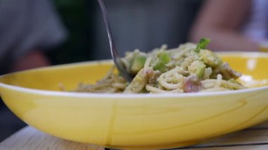 Parmesan, avokado ve pastırma ile İtalyan makarna carbonara yemek. Yavaş çekim. Closeup