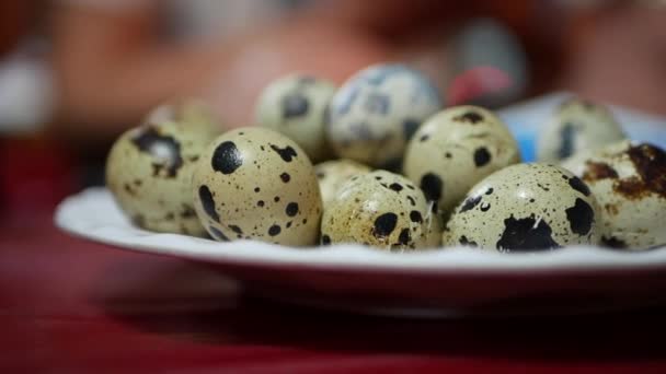 Female hand takes small quail egg from the plate on table at night asian market. Closeup of fresh quail eggs — Stock Video