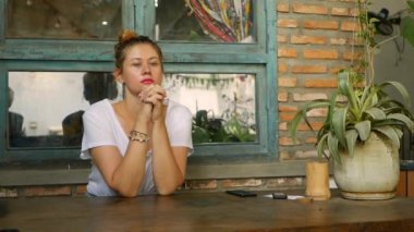 Düşünceli kız restoranda tek başına oturmuş emirlerini bekliyor. Kahvaltı zamanı.