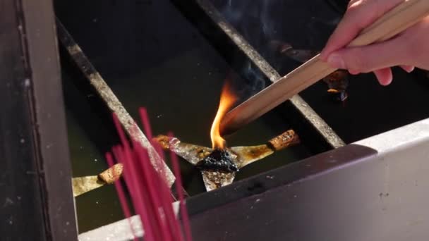 People lightening up their incense sticks during the celebration of Chinese New Year. Close-up. 4k — Stock Video