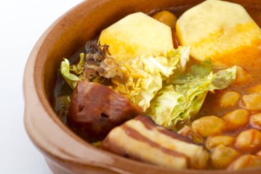 Cocido de Madrid, geleneksel İspanyol Nohut ile çanağı. et, sasuages ve tipik bir tabak üzerinde beyaz izole sebze
