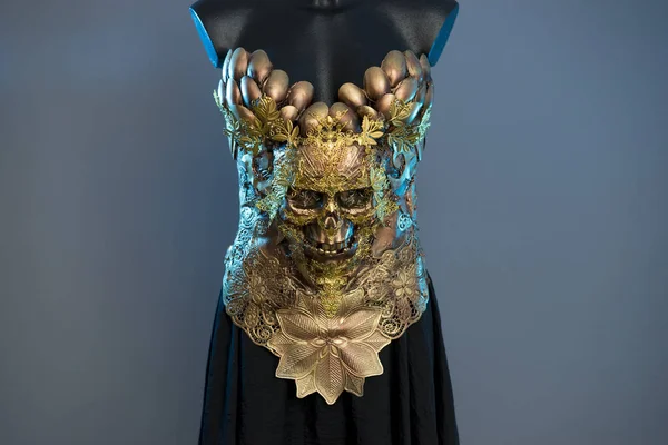 Female Gold Fashion Model Dress, gothic design with golden skull. golden pieces and copper metal decoration