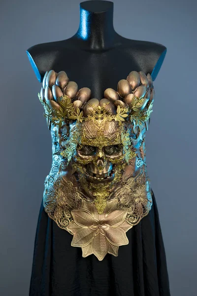 Female Gold Fashion Model Dress, gothic design with golden skull. golden pieces and copper metal decoration