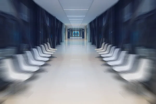 Motion blur, White hospital lobby with a door and white chairs for patients waiting for the doctor visit