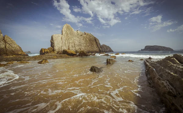 Stock image Beach with rocks in summer. Playa de la Arna in Santander, Spain 