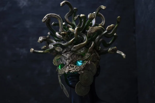 Head Medusa, creature of Greek mythology. pieces made by hand with goldsmiths and metals such as gold and copper. wears a helmet of green and gold snakes