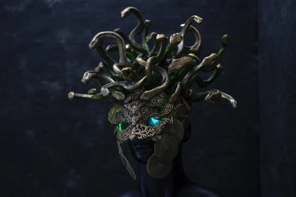 Head Medusa, creature of Greek mythology. pieces made by hand with goldsmiths and metals such as gold and copper. wears a helmet of green and gold snakes