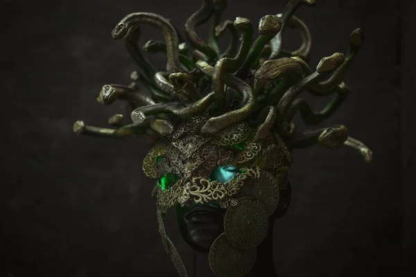 Medusa, creature of Greek mythology. pieces made by hand with goldsmiths and metals such as gold and copper. wears a helmet of green and gold snakes