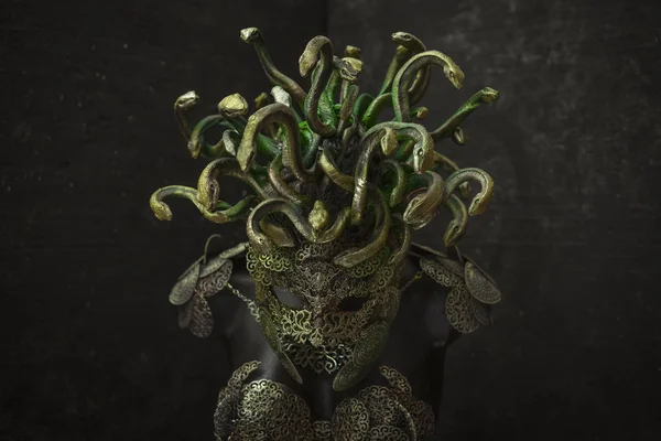 Medusa, creature of Greek mythology. pieces made by hand with goldsmiths and metals such as gold and copper. wears a helmet of green and gold snakes