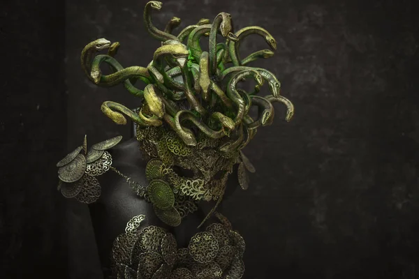 Medusa, creature of Greek mythology. pieces made by hand with goldsmiths and metals such as gold and copper. wears a helmet of green and gold snakes