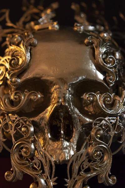 Gold, golden skull made with 3d printer . Gothic piece of decoration for halloween or horror scenes