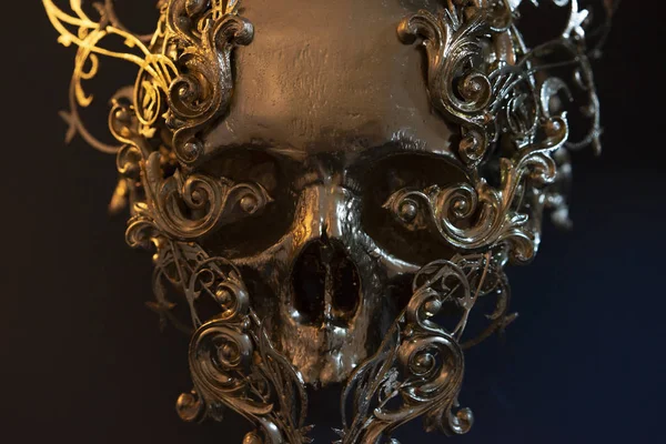 Gold, golden skull made with 3d printer . Gothic piece of decoration for halloween or horror scenes