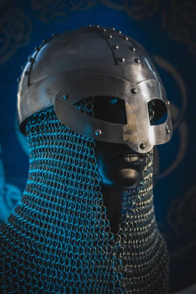 Triskel, Vikings, viking helmet with chain mail on a red shield with golden shapes of sun, weapons for war