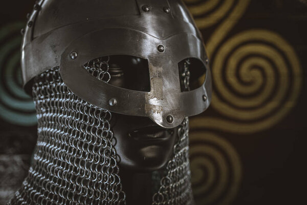 Costume Vikings, viking helmet with chain mail on a red shield with golden shapes of sun, weapons for war