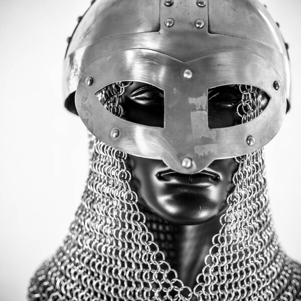 Metal, Viking helmet with chain mail in a black mannequin on white background. clothes for the viking war