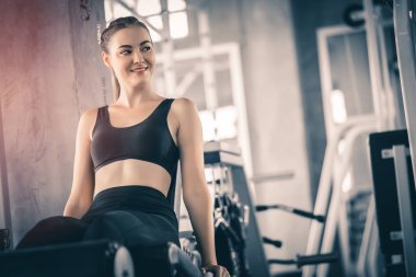 Güzel genç kadın egzersiz egzersiz jimnastik salonu makinedeki uygun. Memnun gülümseyen kız onu eğitim süreci ile keyfini çıkarın. Fitness, sağlıklı, spor, yaşam kavramı