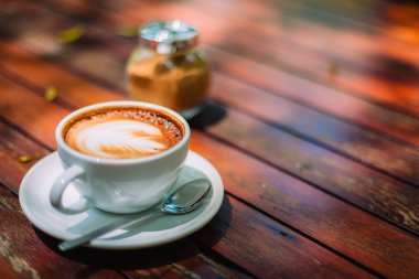 Sıcak kahve latte kapuçino sarmal köpük kahve dükkanı Cafe vintage renk tonu filtre arka plan ile ahşap masa üzerinde. Metniniz için kopya alanı ile. Renk tonu efekti