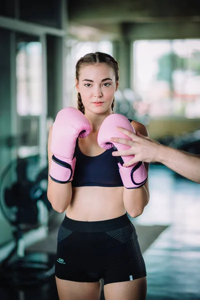 Fit beautiful woman boxer exercise class in a gym. Boxer woman making direct hit dynamic movement. Healthy, sport, lifestyle, Fitness, workout concept. With copy space.
