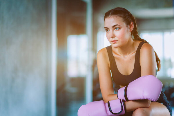 Fit beautiful young woman muay thai boxer exercise class in a gym. Healthy, sport, lifestyle, Fitness, workout concept. With copy space.