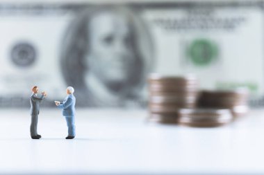 Minyatür insanlar, para destesiyle dolar banknotunun üzerinde duran iş adamı. Risk yönetimi işletmeleri finans ve yatırım yüzdesi faiz oranları kavramının yönetimi. kopyalama alanı ile. 