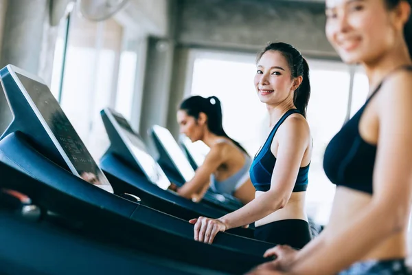 Side view group of healthy attractive sports women on running tr 스톡 이미지