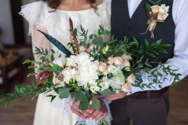 Wedding bouquet of flowers including Red hypericum, Roses, Lilies of the valley, mini Roses, Seeded Eucalyptus, Astilbe, Scabiosa, Pieris, and ivy clipart
