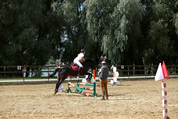 KHMELNYTSKY, UCRANIA, 28 de agosto: Jinete desconocido en un caballo durante los partidos de competición montando obstáculos redondos — Foto de Stock