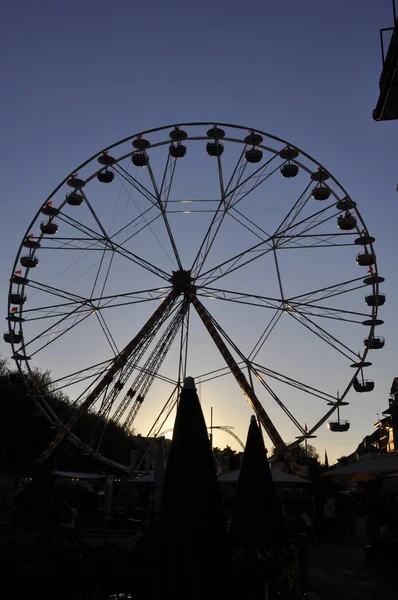 Attraction wheel review over park at summer evening time