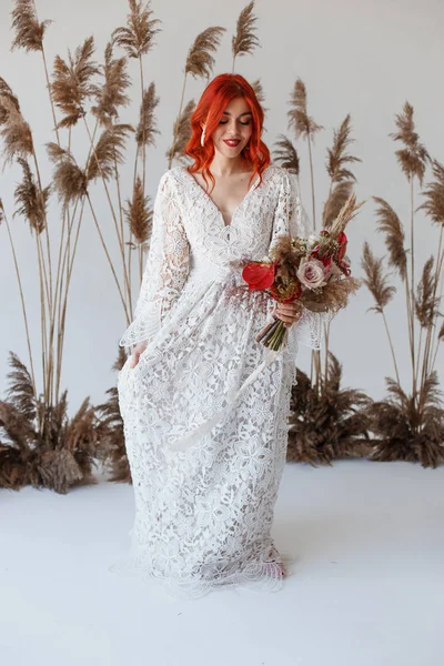 Wedding content - close-up Portrait of a young beautiful redhair girl in a studio standing on a white background with a decorations. Copy space — Stock Photo, Image