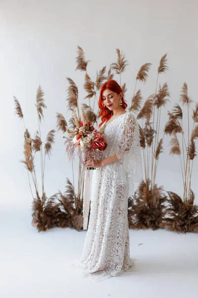 Wedding content - close-up Portrait of a young beautiful redhair girl in a studio standing on a white background with a decorations. Copy space — Stock Photo, Image