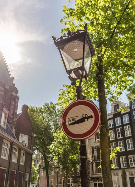 Alcohol prohibition sign on the vintage street lamp in Amsterdam city, Netherlands. The sign prohibits drinking alcohol beverages on the street.