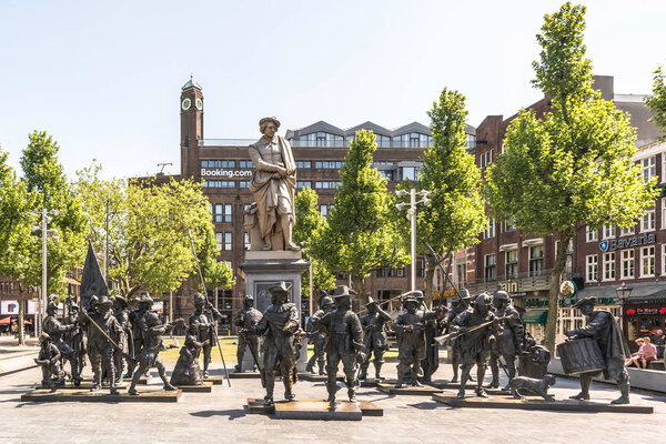 Amsterdam, Netherlands - May 21, 2018: The cast iron statue of Rembrandt and the bronze-cast sculptures of his most famous painting, the Night Watch, in 3D at the Rembrandtplein (Rembrandt Square).