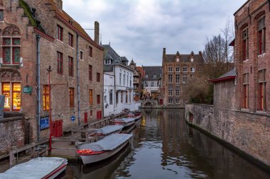 Kırmızı tuğla, kanal, tekne rıhtım ve tekne su geleneksel ortaçağ evleri ile Bruges eski sokak. Bruges sokakları Şehir Manzarası.