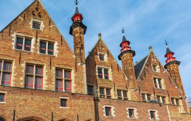 Canal side exterior view of Landhuis van het Brugse Vrije (Palace of the Liberty of Bruges) in Bruges, Belgium. Cityscape of Bruges streets shot from the boat.