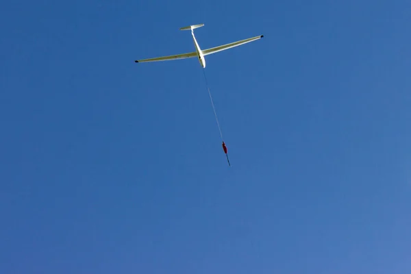 glider at winch start on blue sky in south germany autumn sunny afternoon