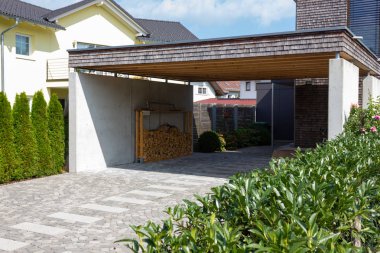 wooden and modern carport in south germany bavarian village area clipart