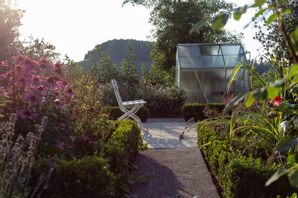 cottage garden plastic shed on a summer evening in south german bavaria countryside